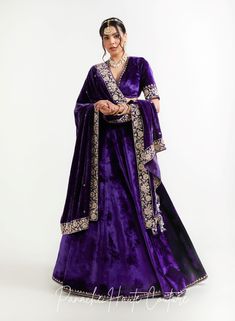 The violet color of lehenga set adds a regal touch, while the shawl can provide an additional layer of warmth and elegance. It is adorned with intricate embroidery, sequins, or other embellishments to make it stand out. When wearing a lehenga set, it's important to choose accessories that complement the outfit without overpowering it. A simple pair of earrings, a bracelet, and a clutch in a complementary color can be all that is needed to complete the look. Overall, a Violet Color Lehenga Set with a shawl from the Sensual Shadows Collection can be a stunning choice for anyone looking to make a statement with their fashion choices. The vibrant colors and intricate details are sure to turn heads and make the wearer feel like royalty. Brand: Panache Haute Couture Collection Name: The Sensual Purple Anarkali Pre-draped Saree For Reception, Purple Pre-draped Saree For Wedding, Elegant Purple Choli With Traditional Drape, Reception Purple Pre-draped Saree With Pallu, Purple Sharara For Reception With Traditional Drape, Purple Traditional Drape Sharara For Reception, Purple Pre-draped Saree With Dupatta For Diwali, Purple Pre-draped Saree With Resham Embroidery For Reception, Reception Purple Pre-draped Saree With Resham Embroidery