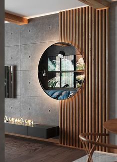 a living room with a round mirror on the wall