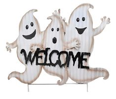 two ghostes are standing next to each other on a welcome sign