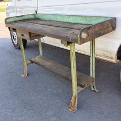 an old table sitting in front of a white van