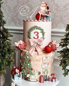 a three tiered cake decorated with christmas decorations