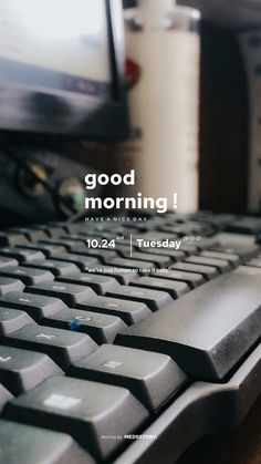 a close up of a keyboard on a desk with the words good morning above it