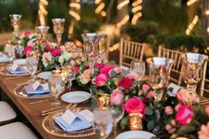 the table is set with place settings, plates and napkins for an elegant dinner