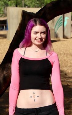 "This long sleeve black and pink crop top fits soft and smooth against your body.  It is made from the popular and sporty raglan cut, and has a black body with pink sleeves and collar. Best paired with: Jeans, cutoff shorts, yoga pants, or your favorite mini-skirt. The model is 5'4\" and wearing a size small. The fabric is stretchy and adjusts to the shape of your body. Although we make every effort to portray the accurate colors, colors and fit may vary slightly from the picture due to lighting and body type, as with all apparel. Size Chart (inches):                              S            M           L Bust                      27-30 31-34    34-37 Natural Waist        26            28    30 Length                        12.5             13     15  Materials:  95% rayon, 5% spandex. Cu Summer Raglan Sleeve Crop Top, High Stretch Pink Casual Crop Top, Fitted Pink Tops With Thumbholes, Fitted Pink Top With Thumbholes, Pink Sports Crop Top, Pink High Stretch Cropped Tops, High Stretch Cropped Pink Tops, High Stretch Pink Cropped Tops, Pink Workout Tops With Thumbholes