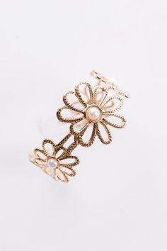 - This sweet bracelet is as cute as a daisy! With an adorable flower design and fabulous faux pearl accents, this piece is channeling flower power. - Gold colored metal material - A flexible cuff design patterned with cute flowers a twist texture and faux pearl accents Cuff Design, Cute Flowers, Metal Material, Flower Design, Garden Party, Flower Power, Cuff Bracelet, Flower Designs, Faux Pearl