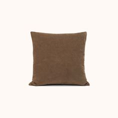 a brown pillow sitting on top of a white wall