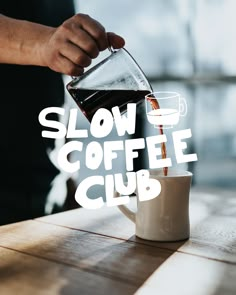 a person pours coffee into a cup on a table with the words slow coffee club