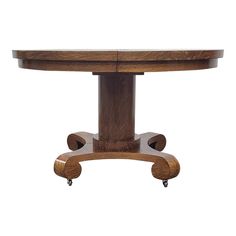 a wooden table with two wheels on it's legs and an oval shaped top