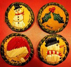 four wooden plates with different designs on them