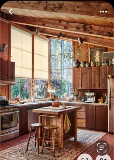 a kitchen with wooden walls and flooring next to a window filled with lots of windows