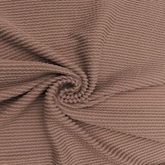 a close up view of the texture of a knitted fabric in light brown color