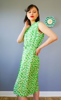 "DESCRIPTION * vintage dress from 1950s by Adele Martin * made with pure silk, in abstract green print * sheath dress style: form-fitting, a straight cut, and the waistline is slightly nipped, accentuating the long slim silhouette. * shirt collar, sleeveless * button down to the hip area * comes with matching belt * beige lining skirt * tag reads \"Adele Martin/ WPL 7588, 100% Pure Silk, Exclusive of Ornamentation, lining and trimming, Dry Clean Only/ Size 12/ Union Label ABFY 160866\" CONDITION Retro Green Midi Length Dress, Vintage Green Midi Length Dress, Fitted Retro Green Midi Dress, 1950s Style Sleeveless Green Dress, Green Vintage Midi Dress For Daywear, Green Sleeveless Retro Vintage Dress, Green Silk Midi Dress For Daywear, Green Fitted Sleeveless Vintage Dress, 1950s Style Green Vintage Dress For Spring