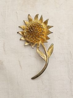 Very unique and different pin. Daisy type flower with wirework 3 dimensional center. The petals have some golden foil backing making them reflect the gold underneath. The pin itself is gold colored but very heavy plating. I have tried to find the maker and there is no marking on back.  Measures approx. 2 3/4 X 2 inch. All original and in excellent working condition. My guess this dates from 1960's - 1970's Gold Flower Brooch Lapel Pin, Vintage Gold Flower Shaped Brooch, Vintage Gold Jewelry With Sunflower Design, Gold Flower Brooch Pins, Vintage Gold Flower Brooch, Vintage Gold Flower Brooches, Gold Flower Lapel Pin, The Maker, Worcester