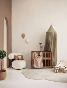 a baby's room with a crib, chair and rug