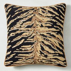 a black and gold pillow with an animal print pattern on it's back side