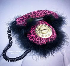 an old fashioned phone with a leopard print and black fur