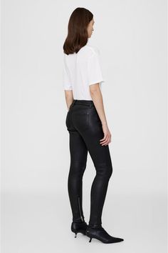 Undeniably 2000s-inspired, the Remy Pant is crafted from soft 100% lamb leather with a stretch backing for comfort and matte finish. This mid-rise style features edgy details including functional zipper pockets in silver hardware and coordinating zipper detailing at each inner leg opening.The Remy Pant is cut for a mid-rise, close fit with an ankle-length inseam. Take your true size.Model is wearing a size 32.Model Measurements: Height: 59.5, Bust: 32, Waist: 23.5, Hips: 34.5Product Measurements Black Leather Pant, Black Leather Pants, Leather Pant, Anine Bing, Leather Trousers, Denim Jumpsuit, Slim Pants, Zipper Detail, Silver Hardware