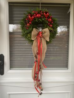 a christmas wreath hanging on the front door