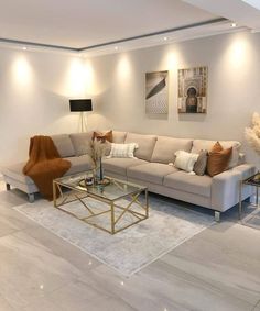 a living room filled with lots of furniture next to a wall mounted painting on the wall