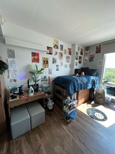 a bedroom with wood floors and pictures on the wall