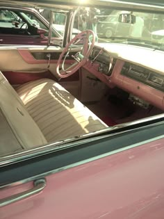 the interior of an old pink car is shown