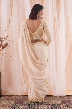 Ivory and beige saree with pearl and cutdana applique work border. Paired with an embroidered blouse with a tasseled hem. - Aza Fashions Beige Saree, Saree Gowns, Dhoti Saree, Cotton Sarees Handloom, Applique Work, Ruffle Saree, Border Saree, Drape Saree, Embroidered Border