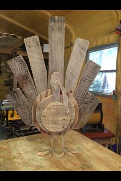 a wooden turkey sitting on top of a table