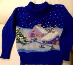 a blue sweater with houses and trees on it