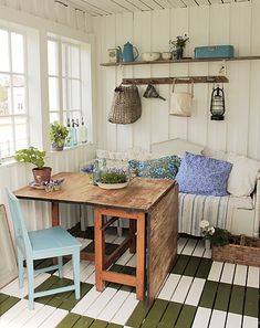 a table and chairs in a room with white walls