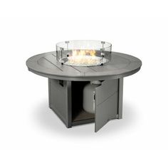 an outdoor fire pit sitting on top of a table