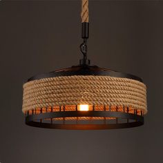 a light that is hanging from a ceiling with rope wrapped around the lightshade