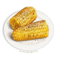 two corn cobs on a white plate with sprinkles and seasoning