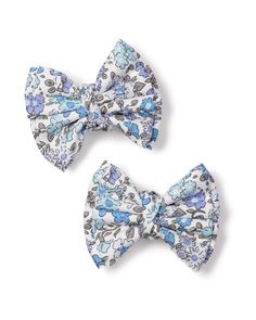 Our girls' hair bows add the same panache as our pajamas, yet in a fun-sized package! The perfect accessory in the same charming fabrics as our beloved pajamas. **Please note, the hair bows cannot be returned.** Measurements: Large bow: 6.5" length x 6" width Medium bow: 4" length x 3" width Baby bow : 3.5" length x 2.5" width Small bow 2 pack: 3" length x 2.5" width Playful Adjustable Bow For Spring, Blue Hair Accessories With Matching Headband For Spring, Playful White Decorative Bow, Blue Adjustable Bow Hair Accessories, Adjustable Blue Bow Hair Accessories, Cute Spring Bow Tie Hair Accessories, Cute Blue Hair Accessories For Summer, Cute Blue Hair Accessories With Headband, Cute Blue Summer Hair Accessories