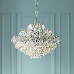 a chandelier hanging from a ceiling in a room with blue walls and white trim