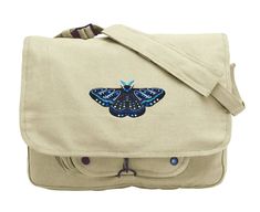 "Patterned shapes and pops of color add dimension and intrigue to this daring moth design. Embroidered on a canvas messenger bag. Vintage Canvas Messenger Bag offers classic styling and functionality and features 3 inner compartments great for storage of books or gear, 1 outer compartment w/ snaps and a fully adjustable shoulder strap. Size: One Size 15\"W x 11\"H x 4\"D. 6.85\"(w) x 3.39\"(h) Strap is approx 40\" from end to end when fully extended Colors of thread in embroidery design, along w Embroidered Canvas Shoulder Bag For Travel, Moth Design, Messanger Bag, Costume Making, Embroidered Canvas, Canvas Messenger Bag, Vintage Canvas, Bag Vintage, Messenger Bags