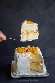 two pieces of cake with fruit on top being lifted by a fork from the bottom