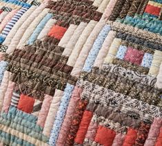 a close up view of a quilt with many different colors and patterns on it's edges