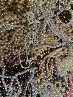 many pearls and other beads are arranged together