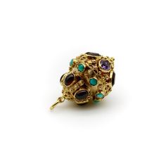 This is part of Chairish's Fine Jewelry assortment.   This vintage 18k gold Italian lantern charm is encrusted with citrine, amethyst, garnet, tourmaline and turquoise, bezel set among Etruscan Revival wirework and granulation. The ornate vintage piece was most likely first purchased at the Ponte Vecchio, a bridge in Florence famous for its jewelry shops and decadent baubles. The charm is oversized—the largest we’ve come across in this style. Layered like a wedding cake, the bottom tier contains Luxury Yellow Gold Gemstones For Jewelry Making, Gold Byzantine Multi-stone Jewelry, Gold Byzantine Jewelry With Multi-stone, Luxury Gold-colored Gemstones, Luxury Gold Pendant Gemstones, Byzantine Multi-stone Jewelry As Gift, Luxury Gold Gemstones For Jewelry Making, Large Lantern, 1960s Vintage