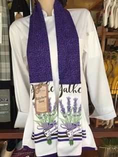 a purple and white scarf with lavenders on it in front of a store display