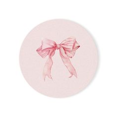 a pink bow on a white plate with watercolors in the bottom and light pink background