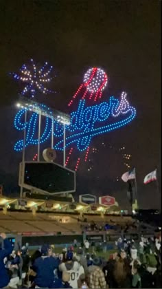 fireworks are lit up in the night sky at a baseball game