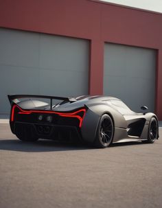 a grey sports car parked in front of a building