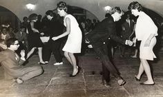 an old black and white photo of people dancing