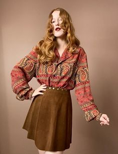 "90s Flowy Button Up Classic bohemian paisley print in red, gold and dark navy blue. Navy buttons down the front. Features a loose fitting collar as well as subtle balloon sleeves. Very lightweight and flowy material. Measurements Shoulders 18\" Bust 48\" Length 26\" Measurements taken with garment laid flat." Bohemian Red Button-up Top, Bohemian Blouse With Vintage Print For Fall, Fall Paisley Print Button-up Blouse, Bohemian Collared Blouse With Buttons, Fall Long Sleeve Blouse With Vintage Pattern, Bohemian Red Tops With Buttons, Vintage Long Sleeve Tops With Boho Print, Fall Button-up Blouse With Vintage Print, Fall Vintage Blouse With Vintage Pattern