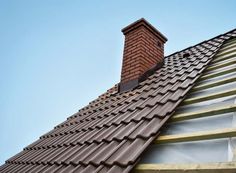 the roof of a house with a brick chimney