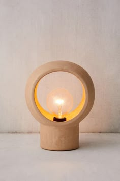 a small light that is on top of a wooden stand with a bulb in it