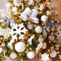 a christmas tree decorated with silver and white ornaments