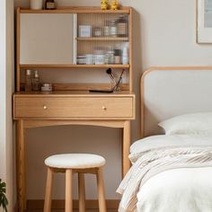 a bedroom scene with focus on the desk and stools in front of the bed