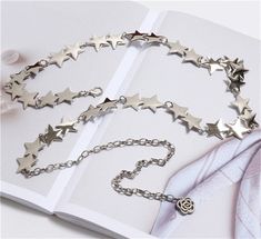 Starry metal chain belt with a rose charm extension. Will fit most sizes because it can be hooked on any part with a jump ring. 28" length of stars, 12" length of extension Trendy Silver Chain Belt As Gift, Trendy Metal Waist Chain Gift, Trendy Metal Waist Chain As Gift, Adjustable Silver Metal Chain Belt, Trendy Metal Waist Chain Perfect As A Gift, Trendy Adjustable Chain Belt As Gift, Metal Chain Belt For Gifts, Metal Chain Belt As Gift, Metal Chain Link Belt For Gift